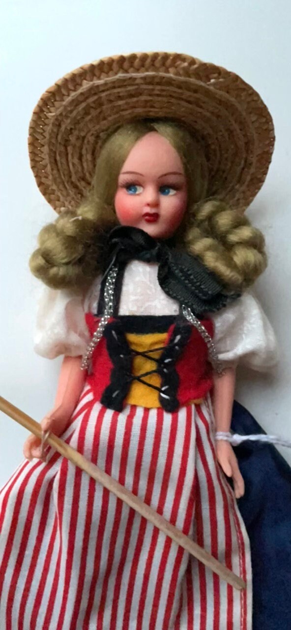 Vintage collectible handmade doll from Luganos Switzerland - with traditional handmade clothing and wooden rake