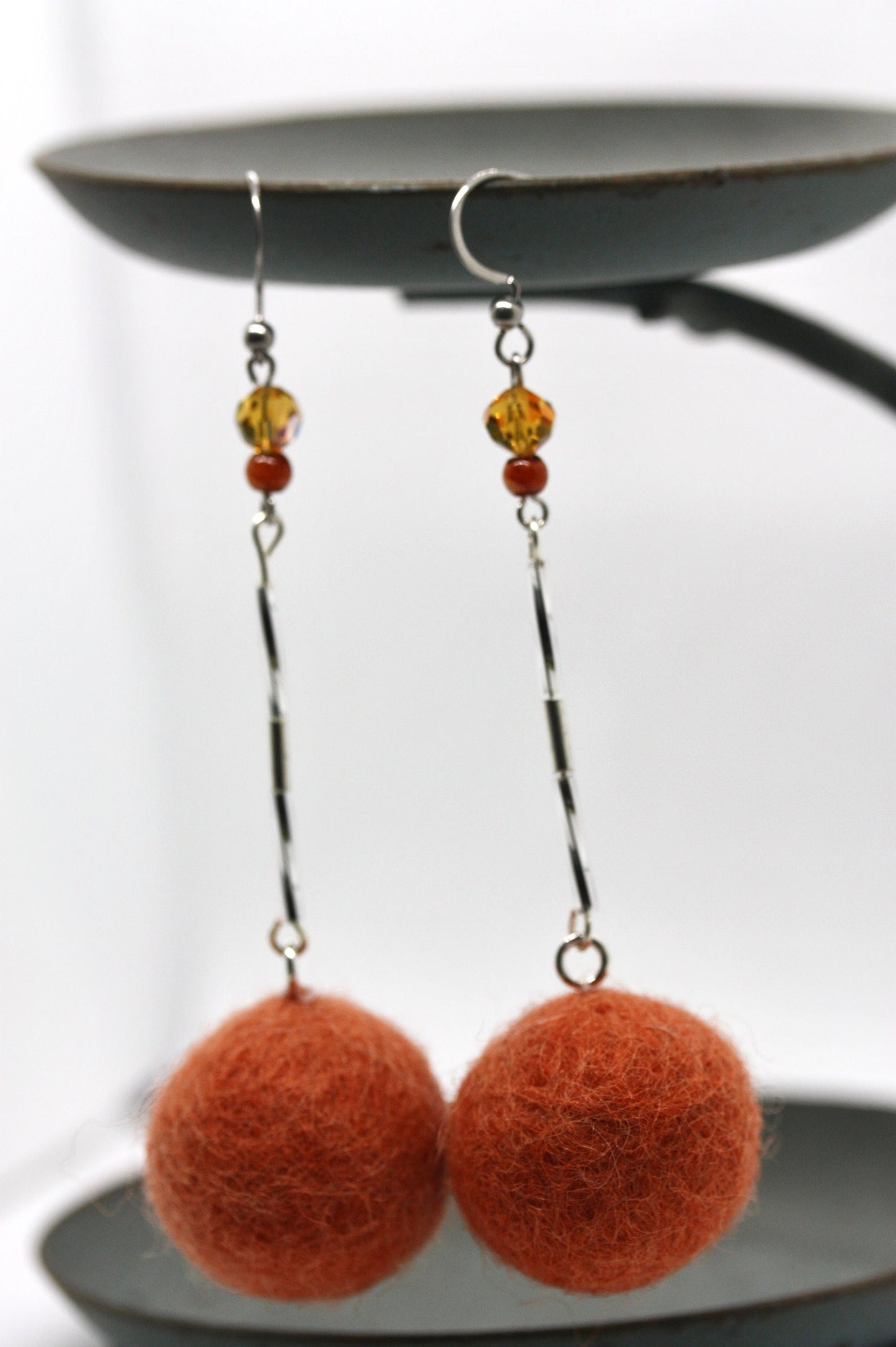 Long, 3.5 inch dangle earrings featuring purchased handmade sheep farm felt coupled with my beedwork
