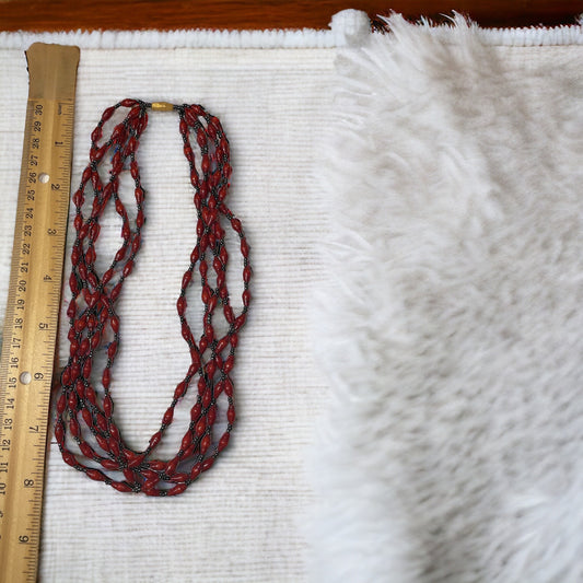 Three-strand necklace made of dozens of itsy bitsy extra tiny little rolled and sealed red paper beads