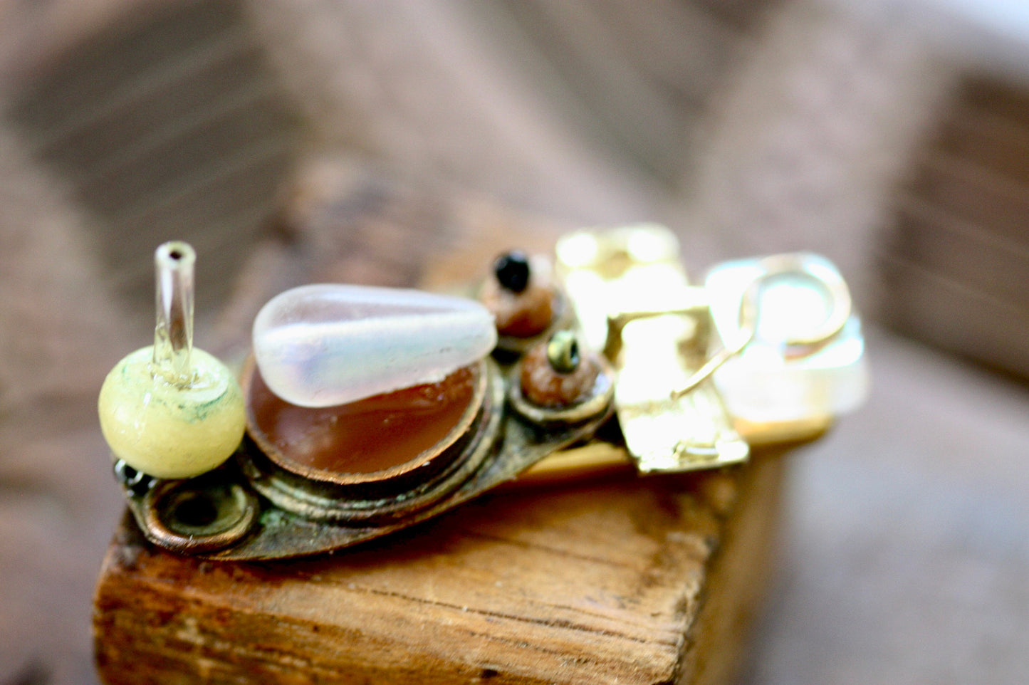 Meet "Joe."  Joe is a really cool assemblage art guy who can be transformed into a necklace, pin, magnet or ring