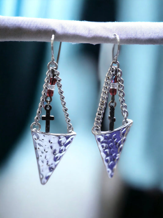Hammered metal triangular dangle earrings with tiny crosses hanging from glass seed beads