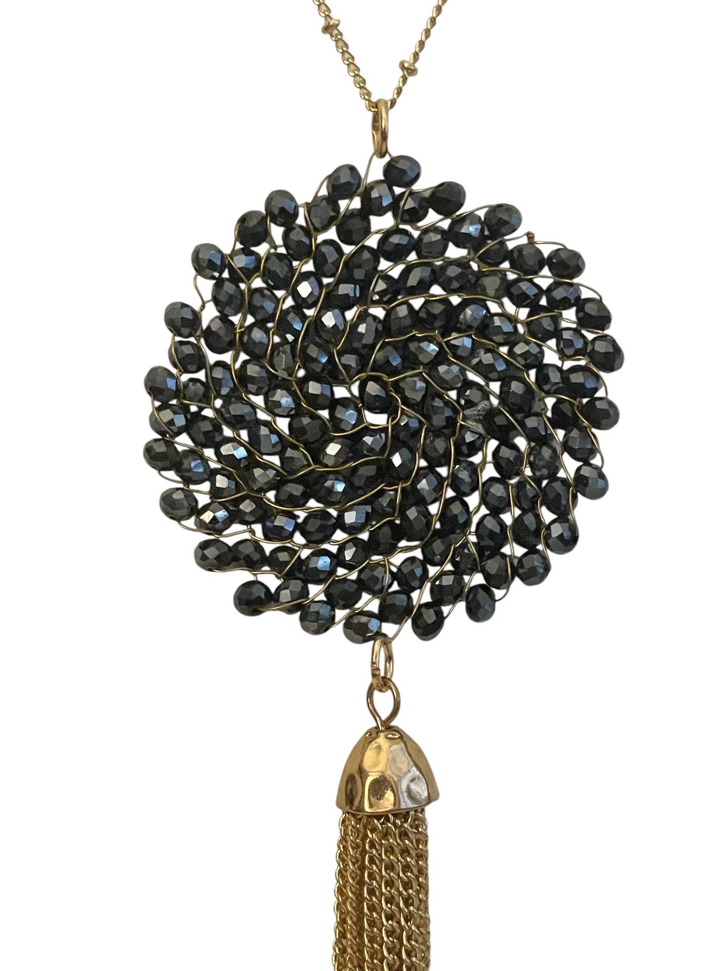 Vintage necklace featuring a black crystal wire linked circular pendant with long goldtone tassel