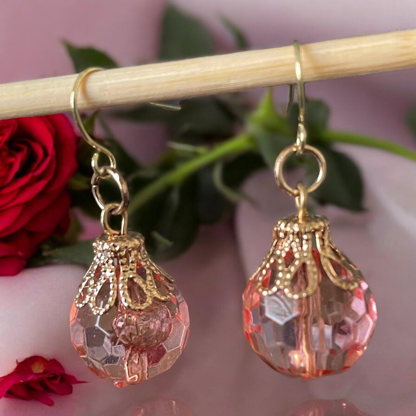 Pink faceted faux crystal earrings with goldstone filigree