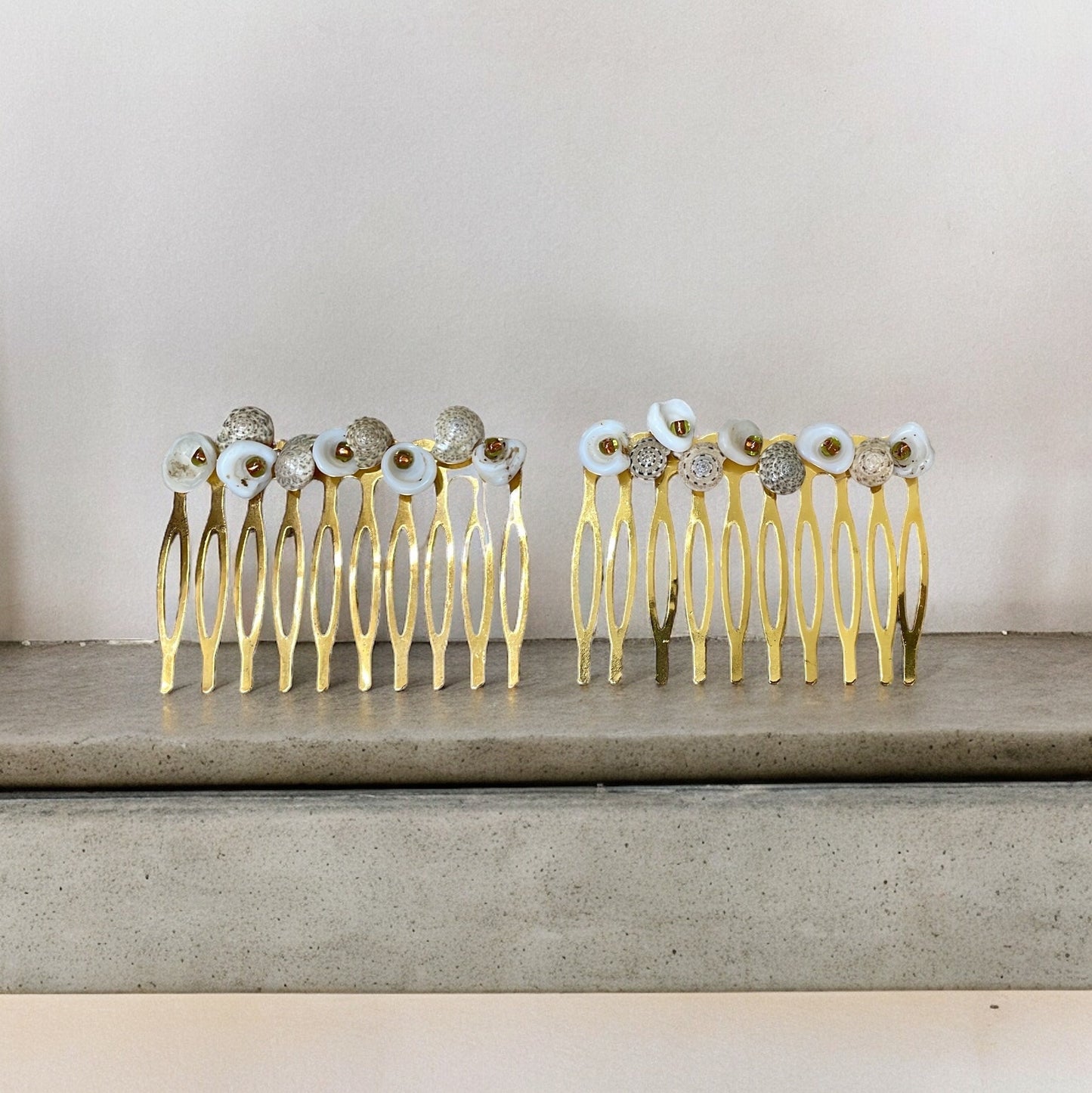 Pair of stunning hand beaded white and striped shell hair combs with burnt orange-gold glass seed beads on goldtone metal hair combs