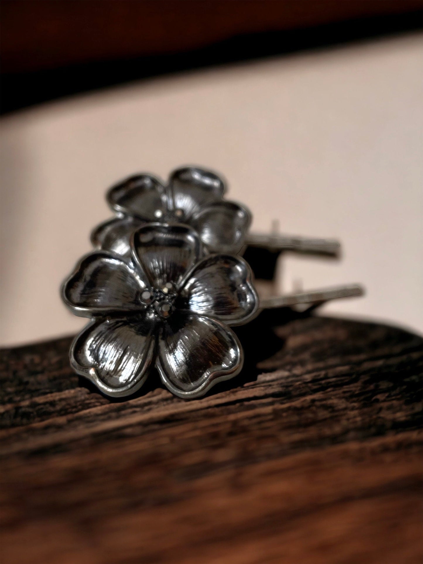 Pair of black flower hair pins with rhinestone centers