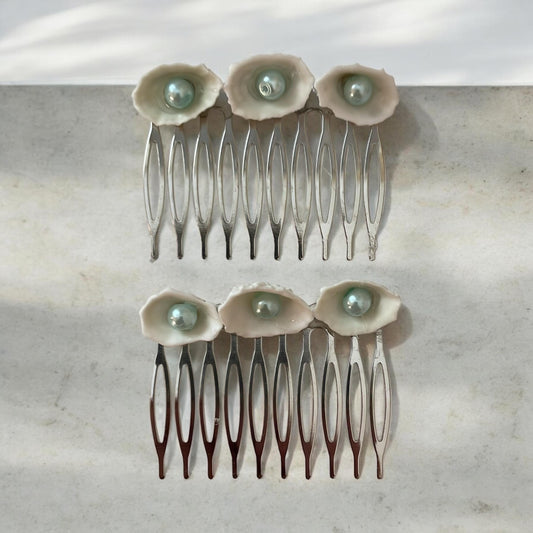 Pair of Hair combs made of white shells with light blue pearl centers
