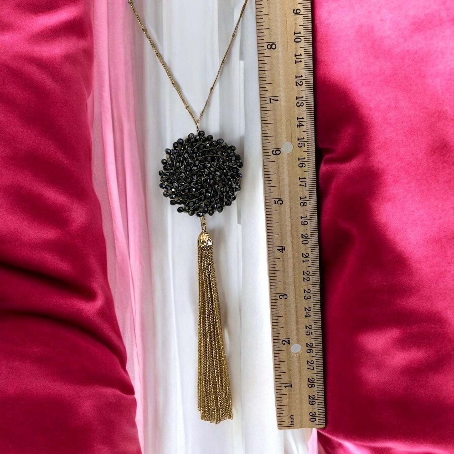 Vintage necklace featuring a black crystal wire linked circular pendant with long goldtone tassel