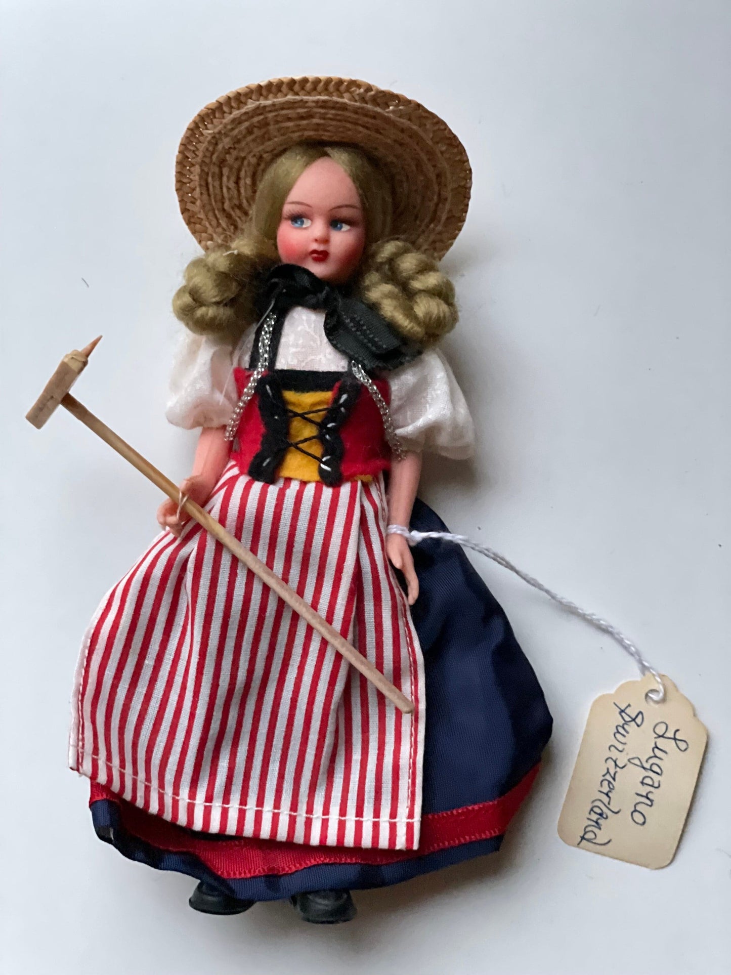 Vintage collectible handmade doll from Luganos Switzerland - with traditional handmade clothing and wooden rake