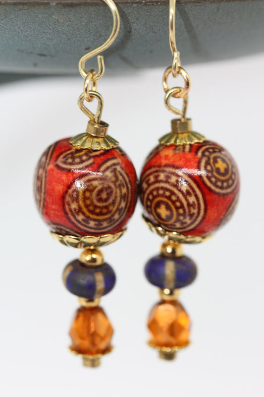 Burnt orange beaded earrings - paper covered beads, purple with cream stripes, orange fire polished crystals