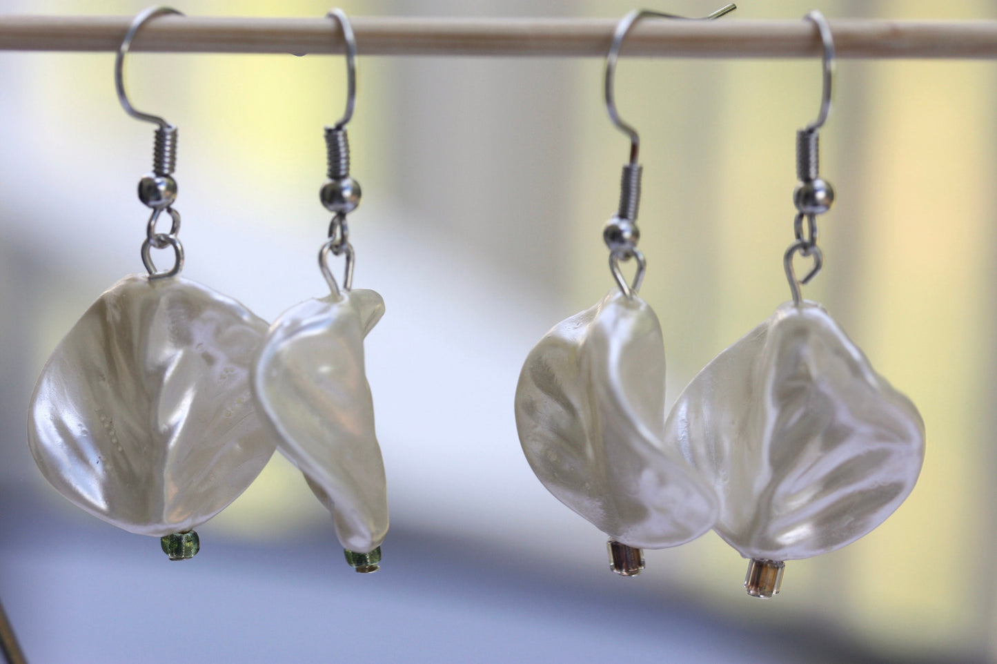 Pearlescent leaves dangle earrings trimmed with tiny sparkly seed beads