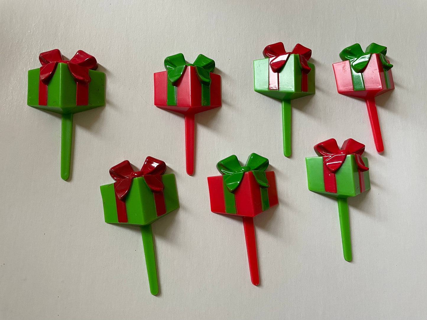 One dozen christmas cupcake toppers - Mix of red and green 3D plastic cake toppers - little wrapped packages with bows