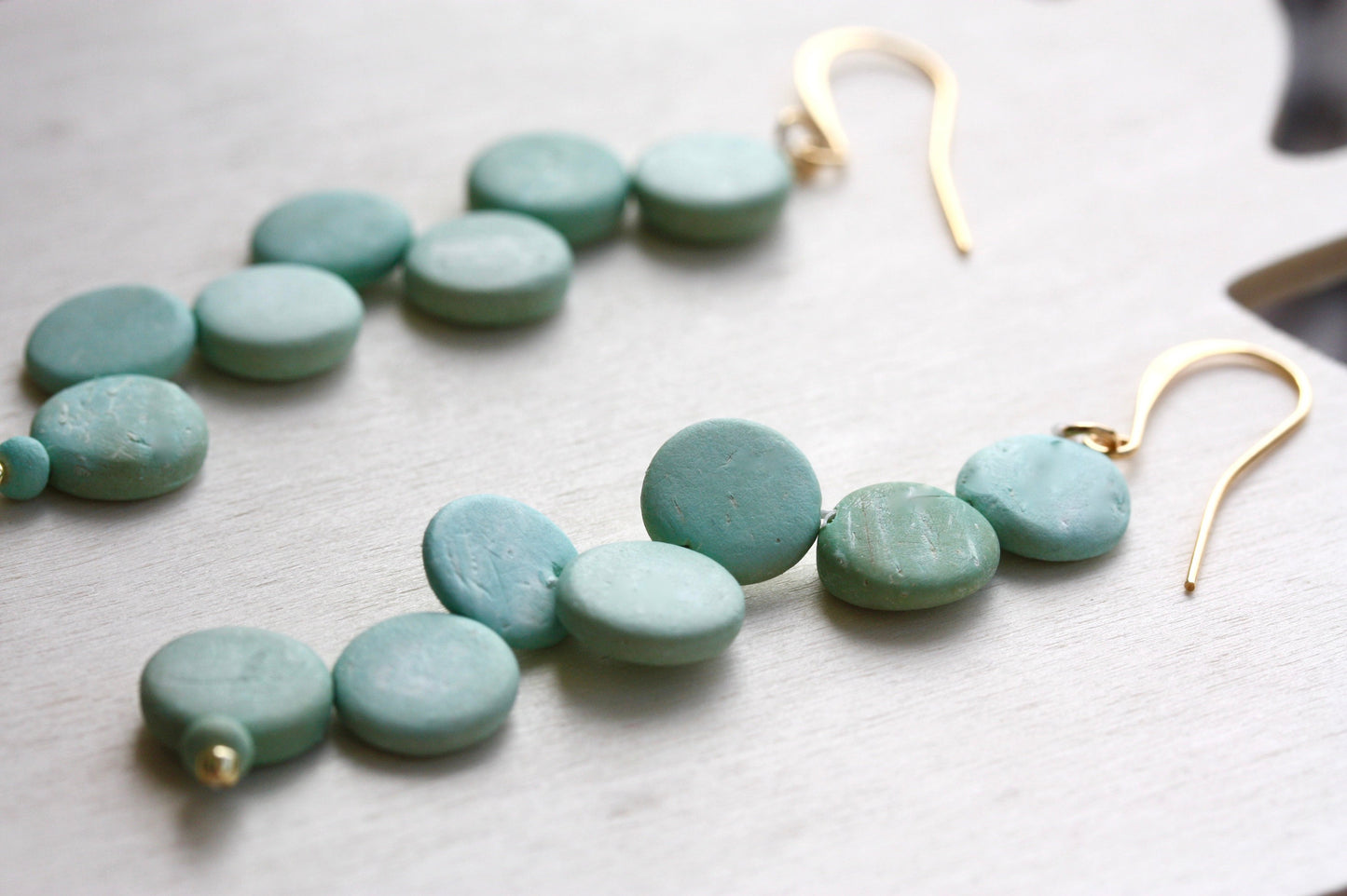 Handsewn aqua tinted wooden disk Scandinavian-inspired earrings - with sloped goldstone ear wires