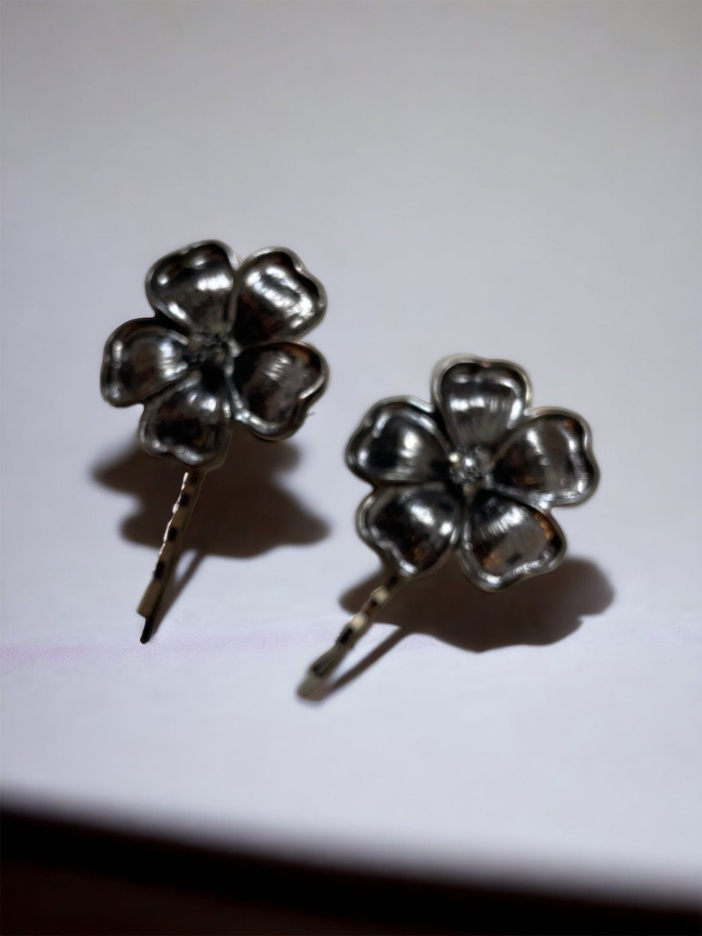 Pair of black flower hair pins with rhinestone centers