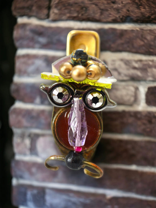 Meet "Henrietta."  Henrietta is a really cool assemblage art gal who can be transformed into a necklace, pin, magnet, bottle or little dish