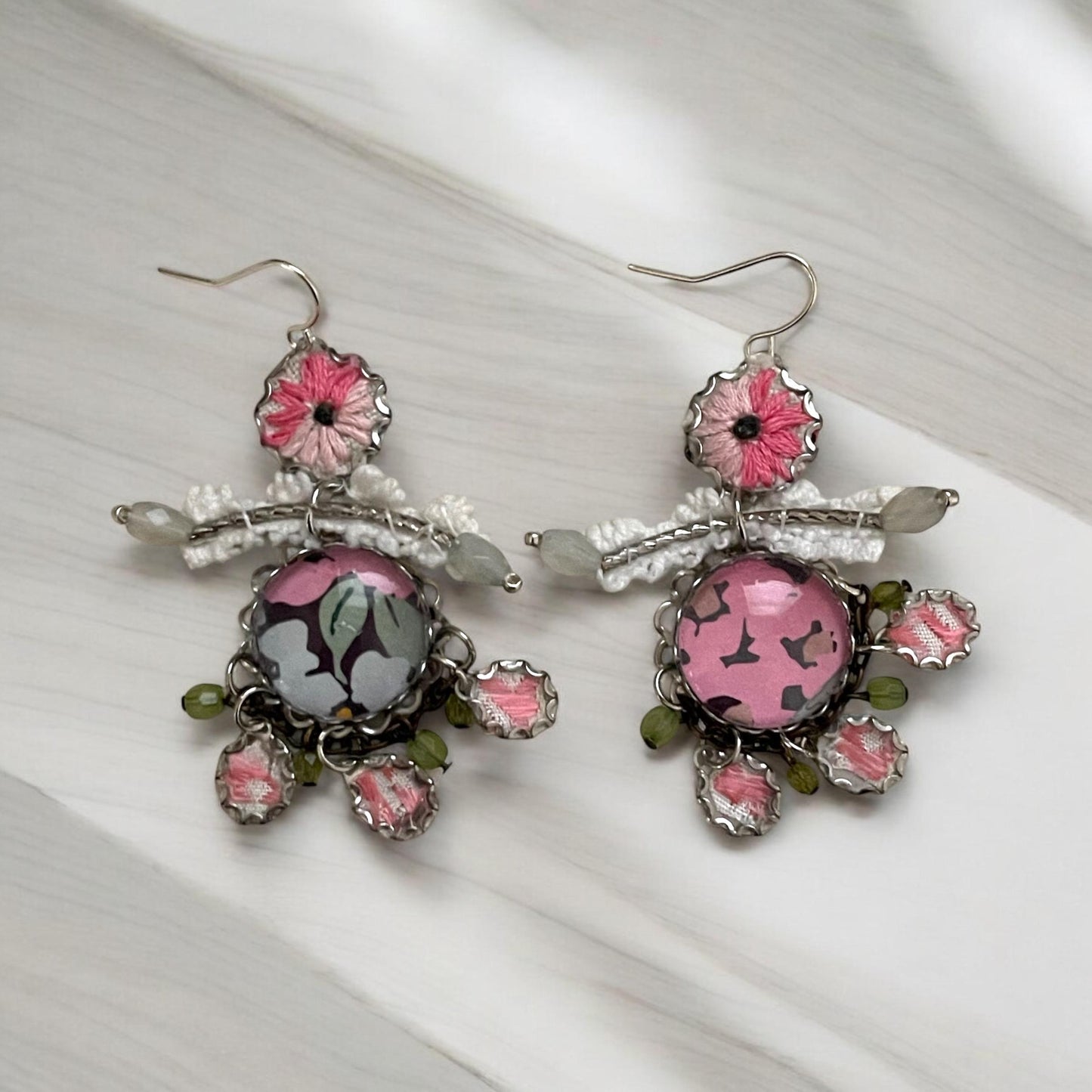 Mixed media earrings made with vintage crochet lace, embroidery from a vintage linen table runner, paper, satiny ribbon and mixed metals