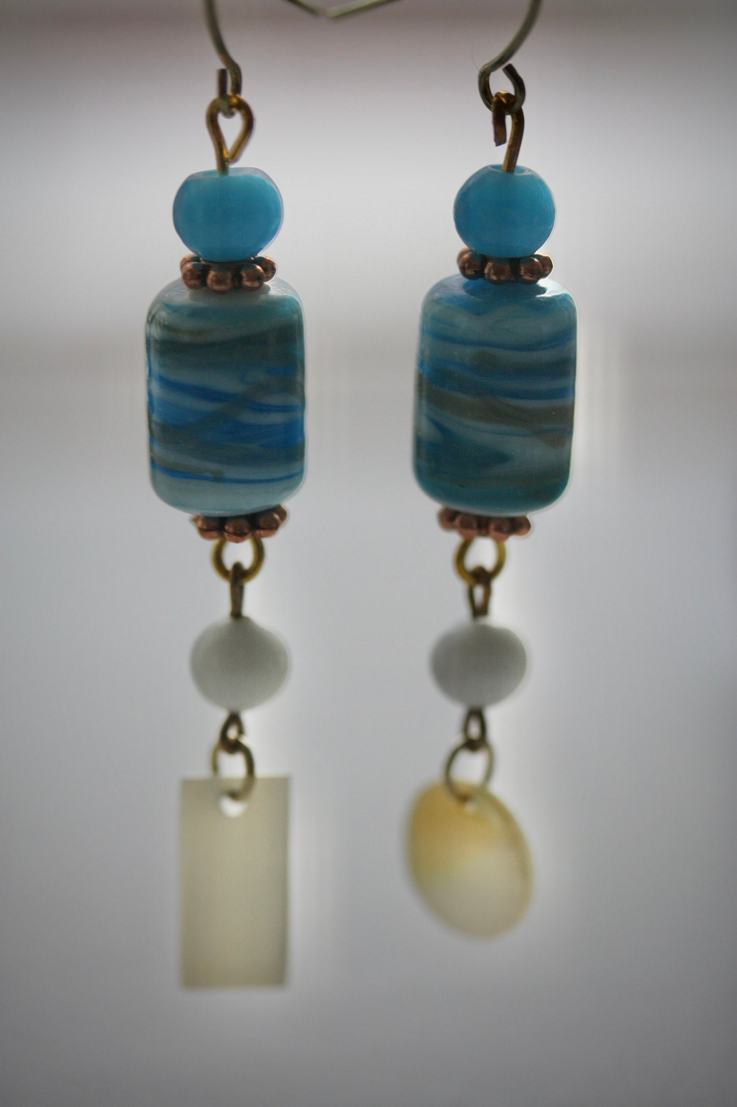 Long dangle earrings made of both new and vintage components -blue and gold art glass, mother of pearl dangles,vintage blue and white beads