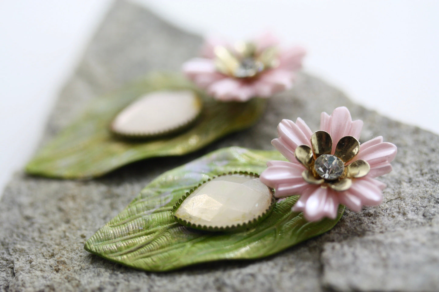 Hand painted leaf earrings with inlaid cabochan, vintage mixed material pink and metal flowers and capped off with rhinestone center