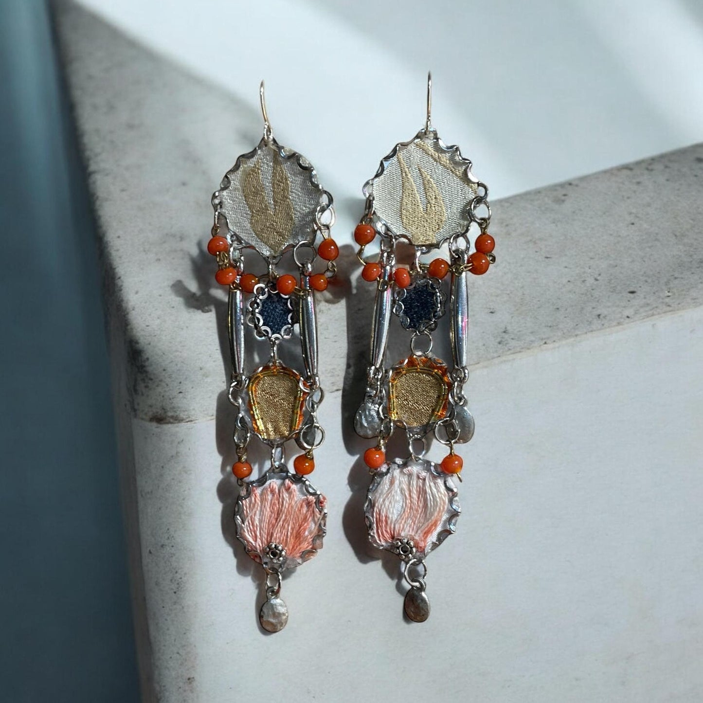Orange and blue denim mixed media collage earrings with mixed fabrics and metals; Sterling silver ear wires