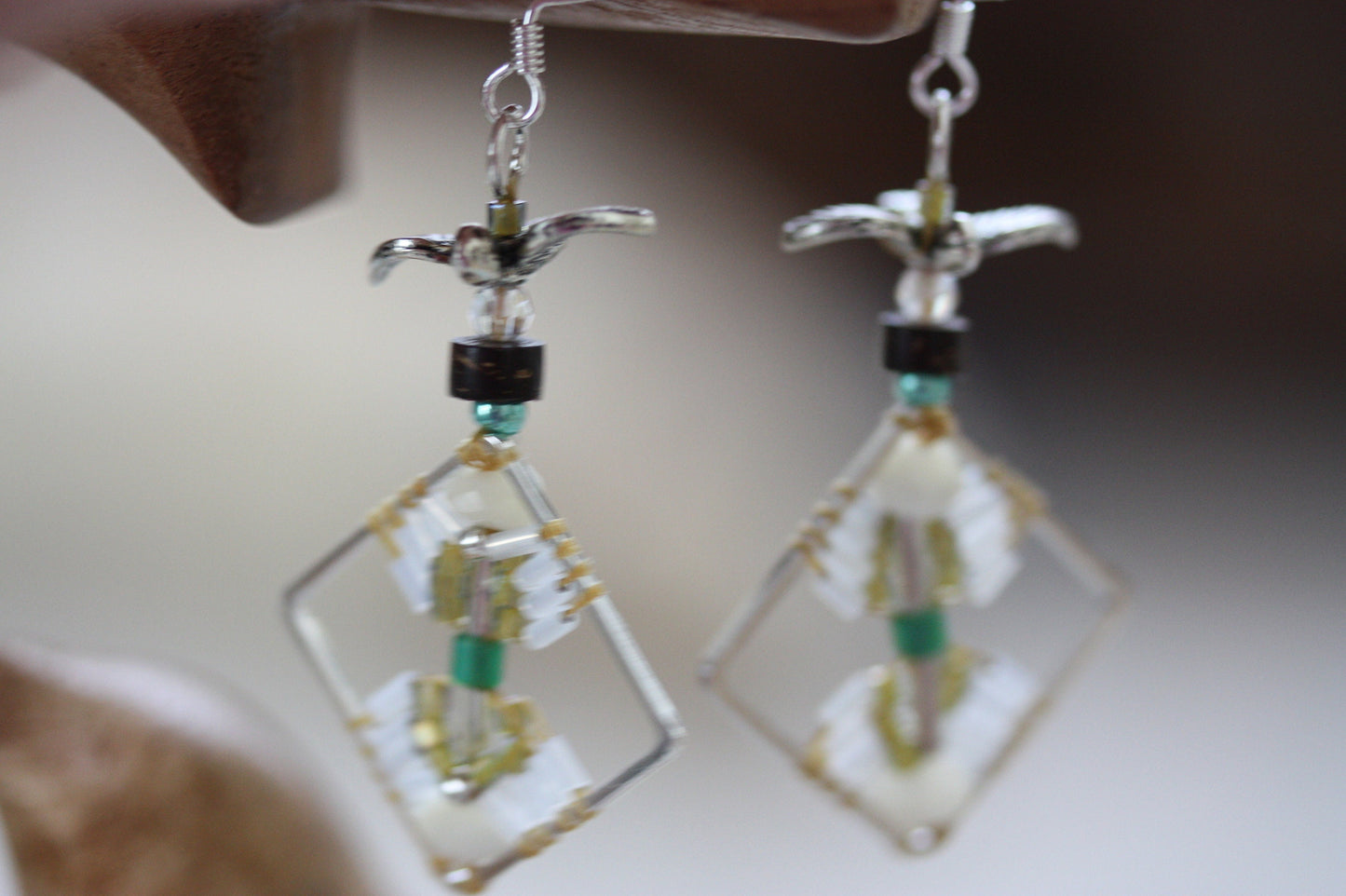 Birds taking flight - intricate beadwork seed bead dangle earrings on diamond-shaped base with flying bird embellishments